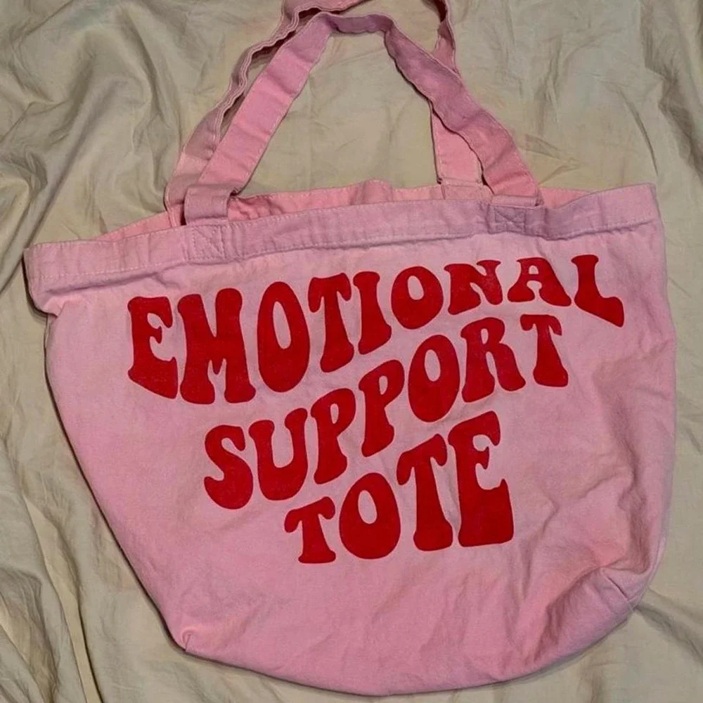 Pink tote bag with red text